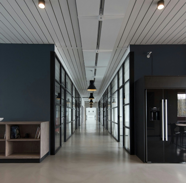 Long hallway featuring a black refrigerator, showcasing JP Gravel Commercial Tenant Fit-ups.