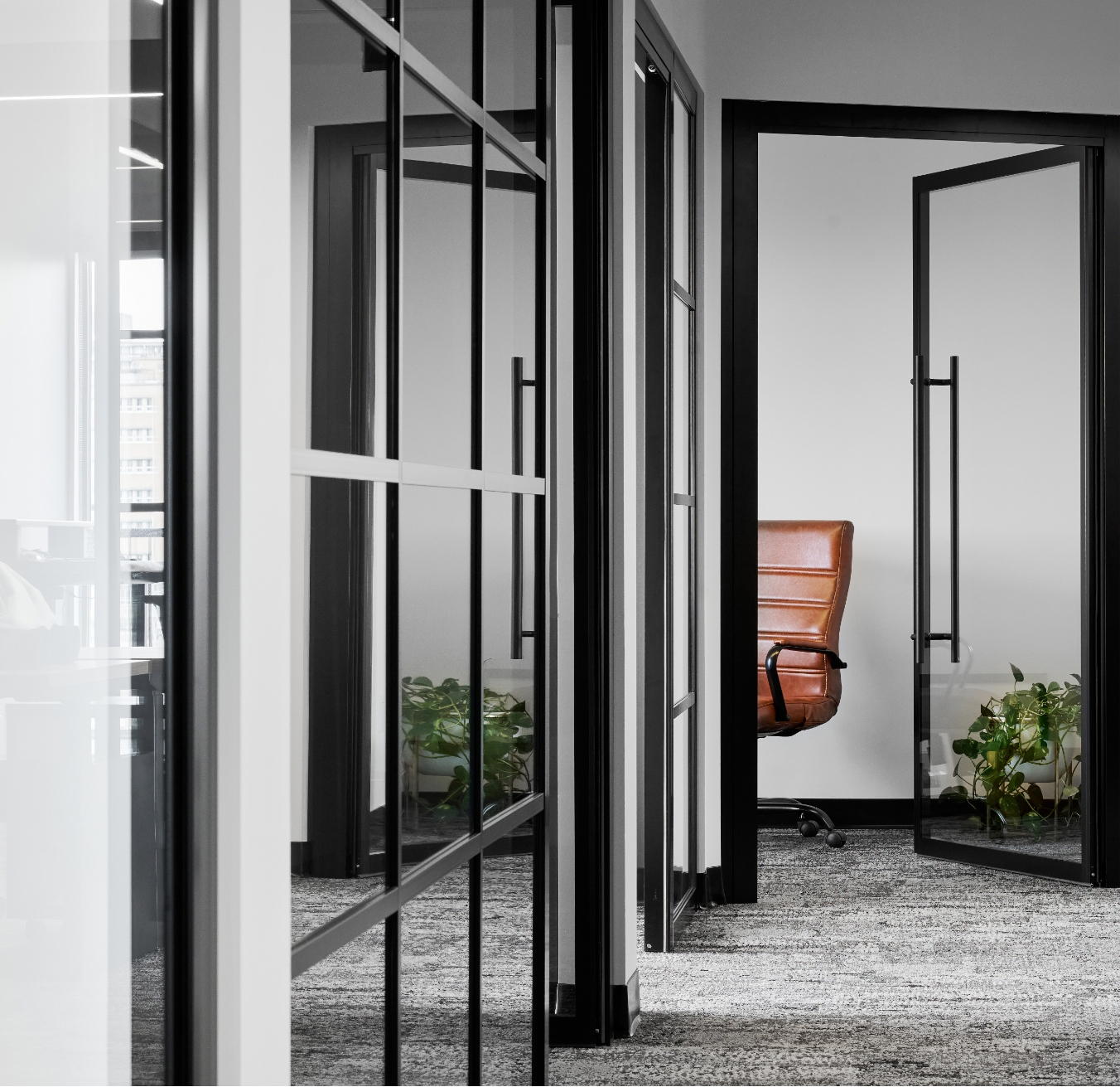 office with glass doors, highlighting the aesthetic of JP Gravel Commercial Tenant Fit-ups.