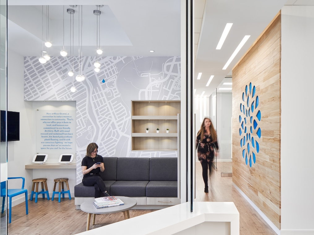 Interior view of an office with a prominent wooden wall and a blue wall, associated with JP Gravel Building Maintenance.