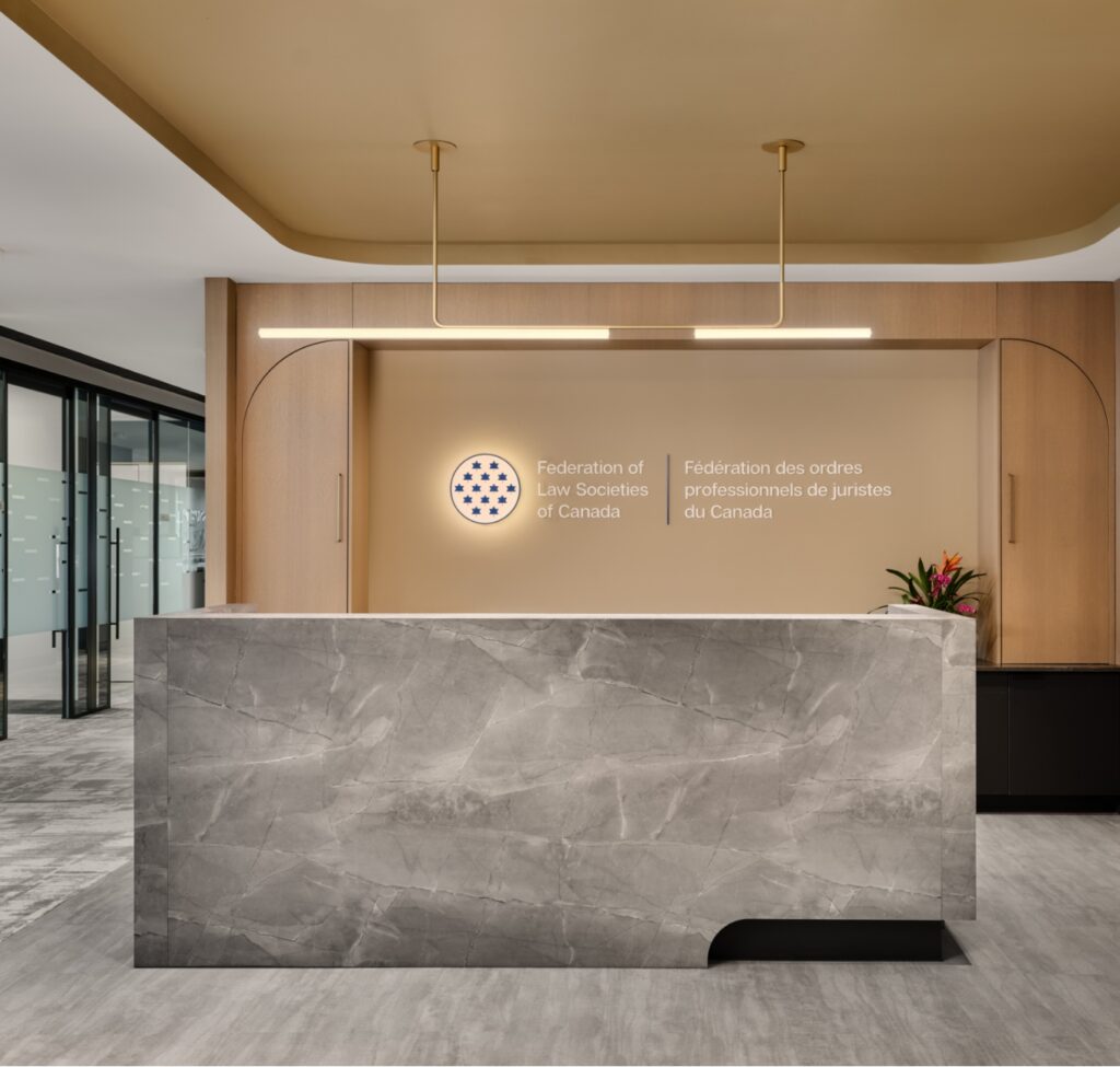 Reception area of an office building featuring elegant marble countertops, showcasing JPG Millwork's sophisticated design.