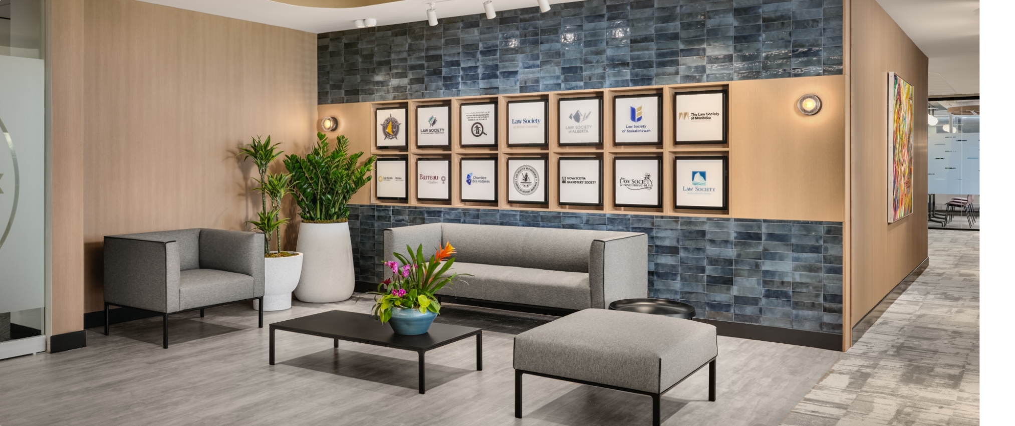Dental office lobby with blue tile walls, highlighting contemporary aesthetics and craftsmanship by JPG Millwork.